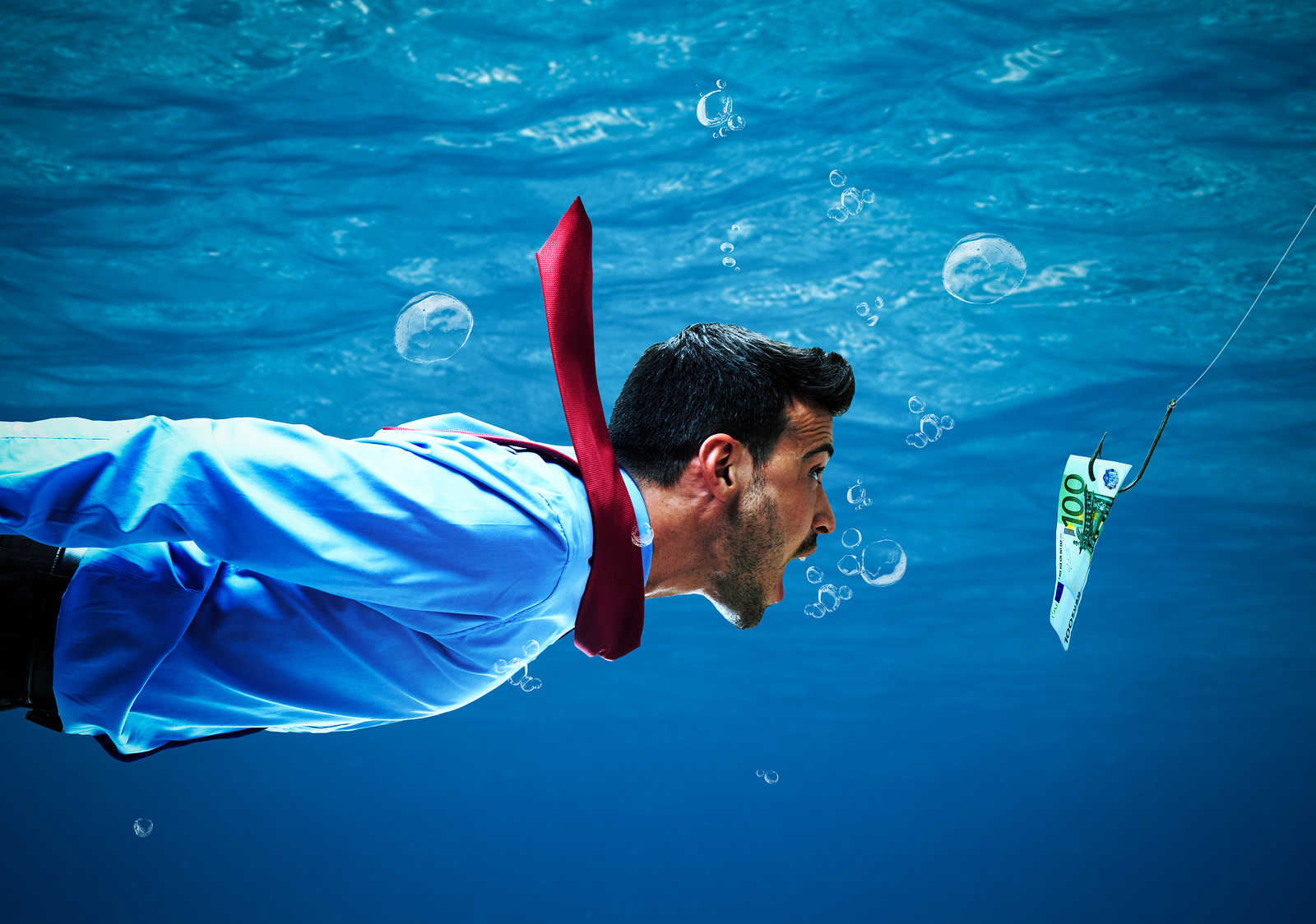 Underwater-scene-of-a-business-man-chasing-money-on-a-fishing-line
